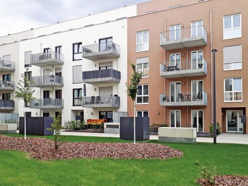 Lawn and small trees in front of residential buildings